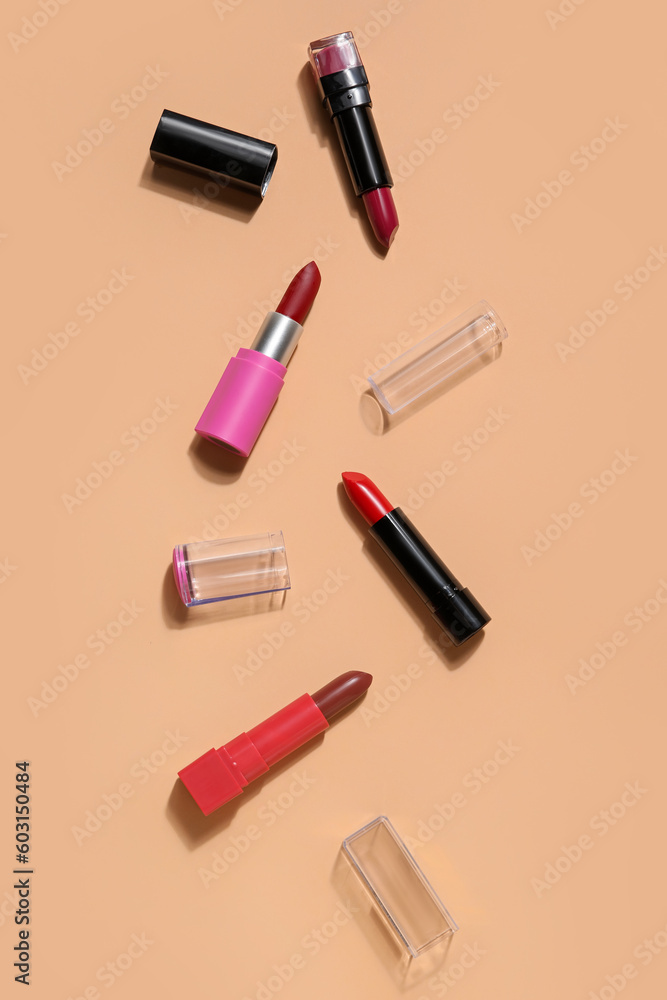 Different lipsticks on beige background