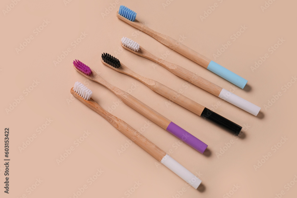 Bamboo toothbrushes on brown background