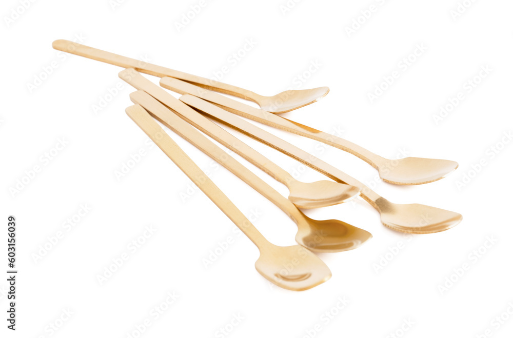 Golden spoons on white background