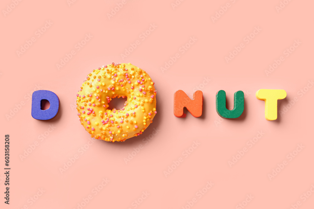 Word DOUGHNUT on pink background