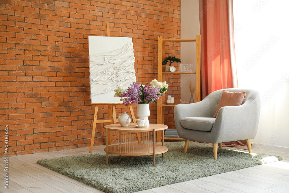 Interior of stylish living room with cozy armchair and lilac flowers on coffee table