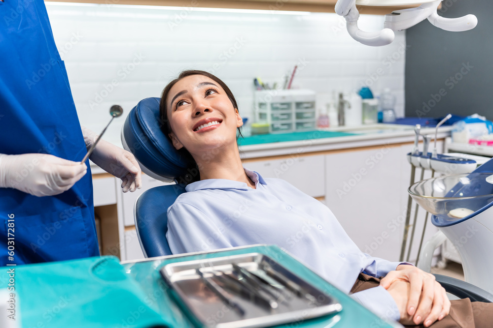 Caucasian dentist examine tooth for young girl at dental health clinic.