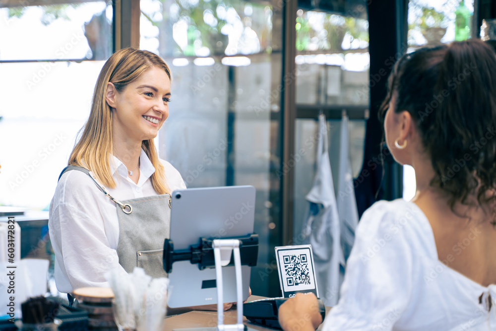 Caucasian attractive women receive coffee from waiter in coffee house.