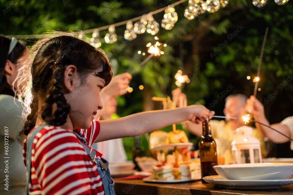 Multi-ethnic big family having fun, enjoy party outdoors in the garden.