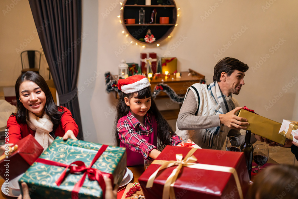 Multi-ethnic family exchanging presents during Christmas party at home.