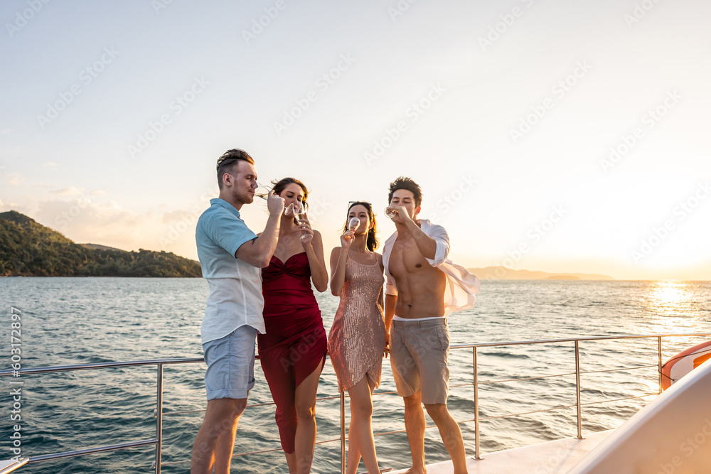 Group of diverse friends drink champagne while having a party in yacht.