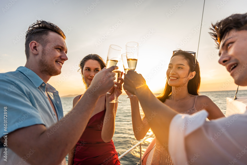 Group of diverse friends drink champagne while having a party in yacht. 