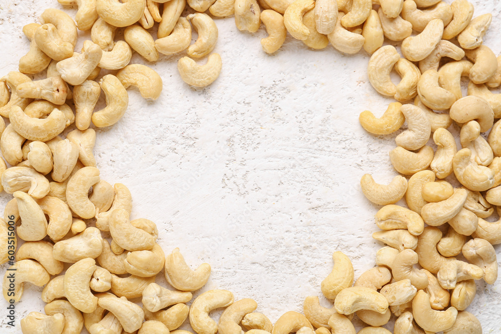 frame made of cashew nuts on light background