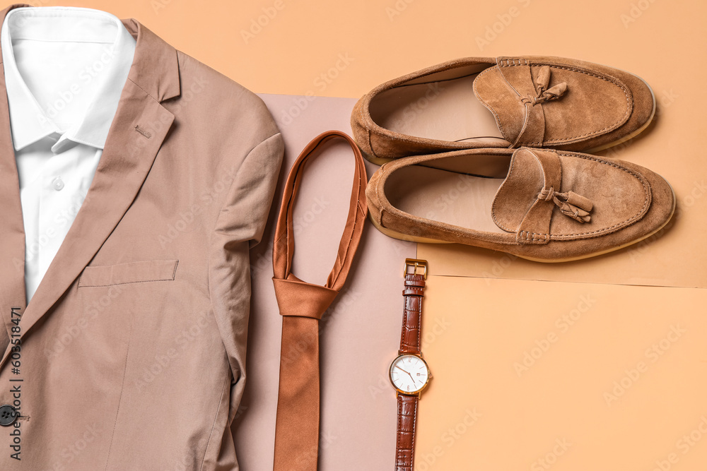 Stylish male clothes with accessories on color background