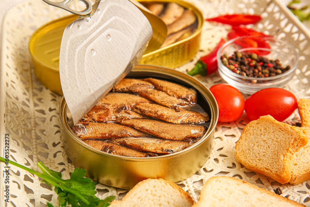 Tray of canned smoked sprats with tomatoes and chilli, closeup