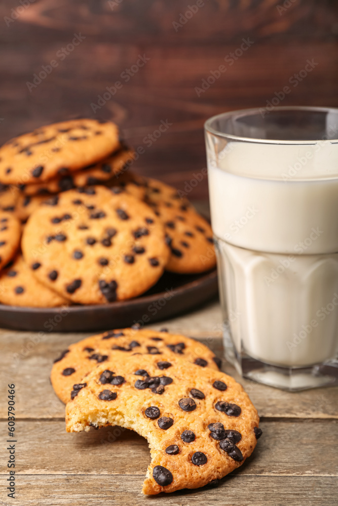 tasty cookies with chocolate chips on wooden background