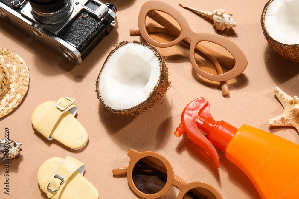 Beach accessories with coconut on beige background