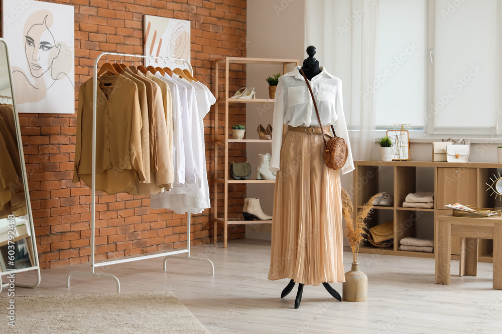 Interior of modern boutique with stylish female clothes and accessories