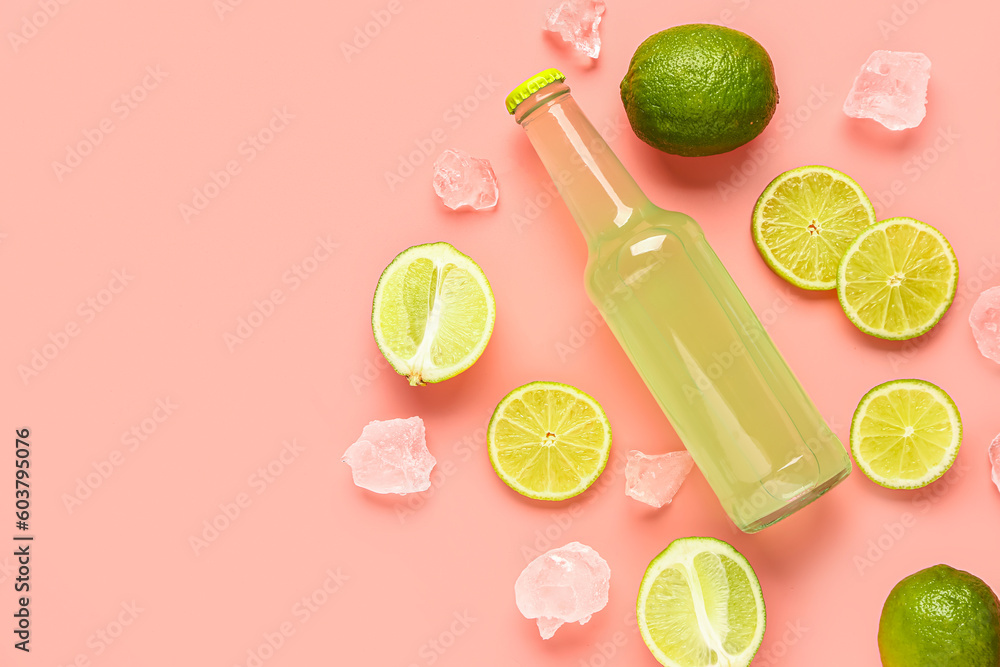 Composition with bottle of fresh soda and lime on pink background