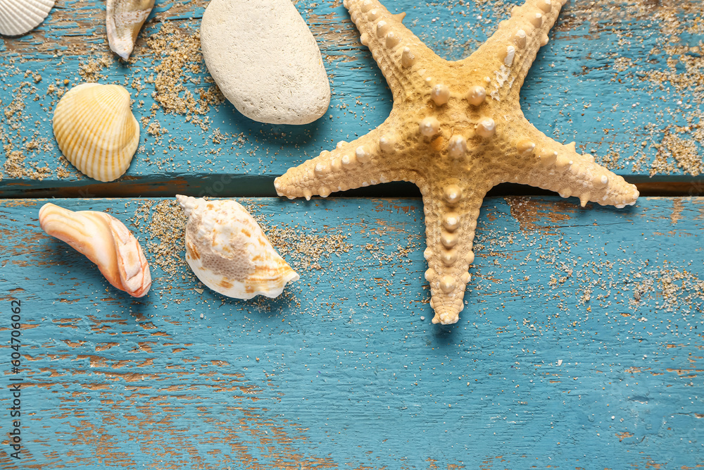 Seashells and starfish on blue wooden background