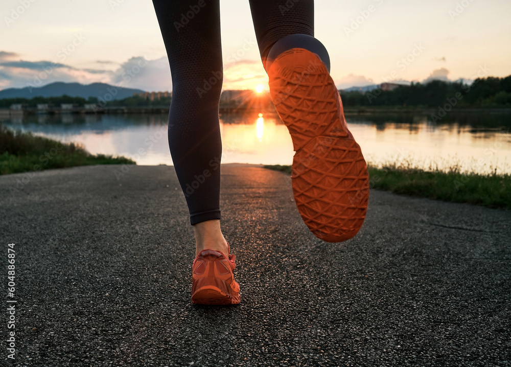 Woman runs in the park on autumn morning. Healthy lifestyle concept, people go in sports outdoors. S