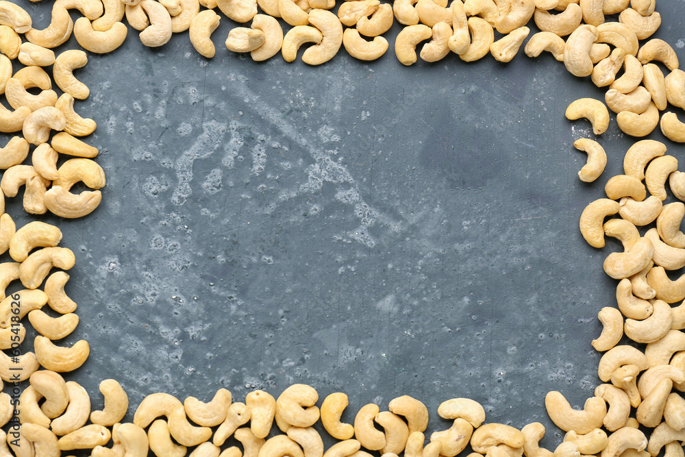 Frame made of tasty cashew nuts on blue background