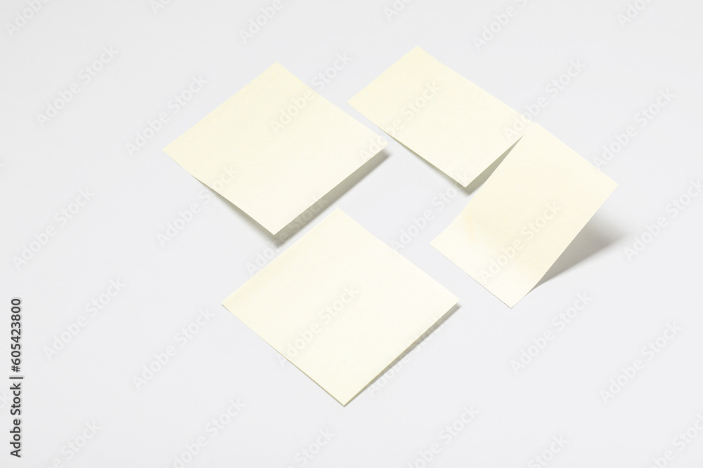 Pale yellow sticky notes on grey background