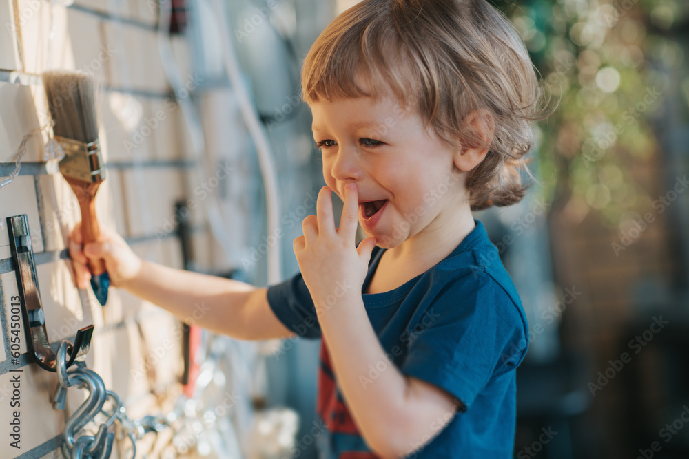 A fun little kid playing with work tools