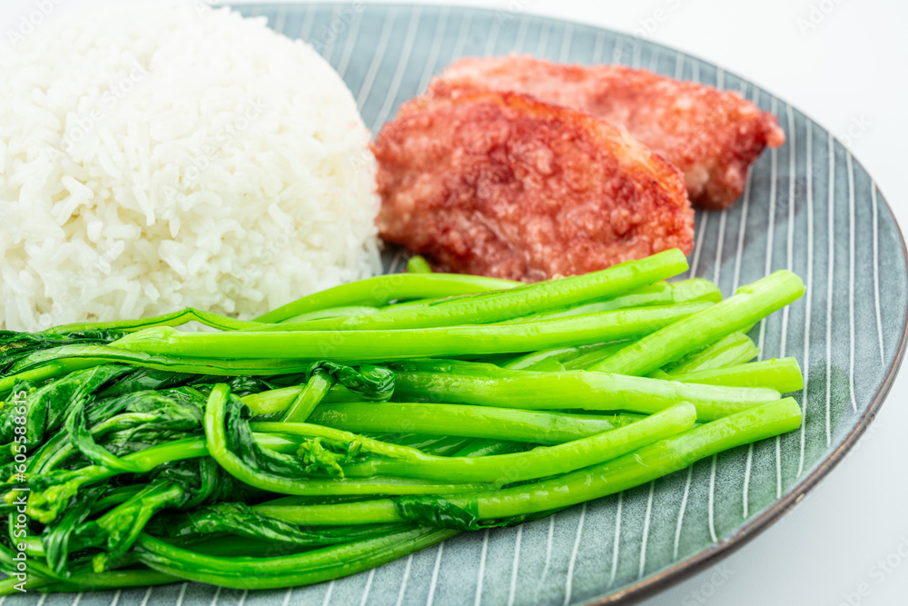 Chinese style meal for one with rice, steamed pork and stir-fried vegetables