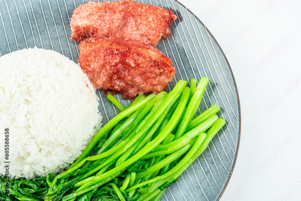 Chinese style meal for one with rice, steamed pork and stir-fried vegetables