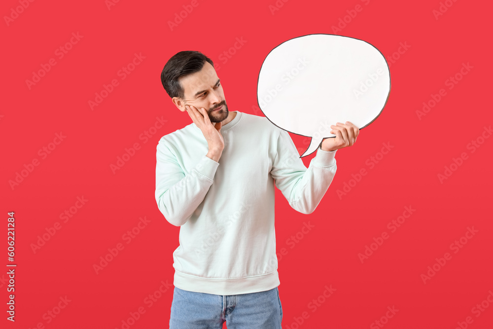 Handsome man with blank speech bubble on red background