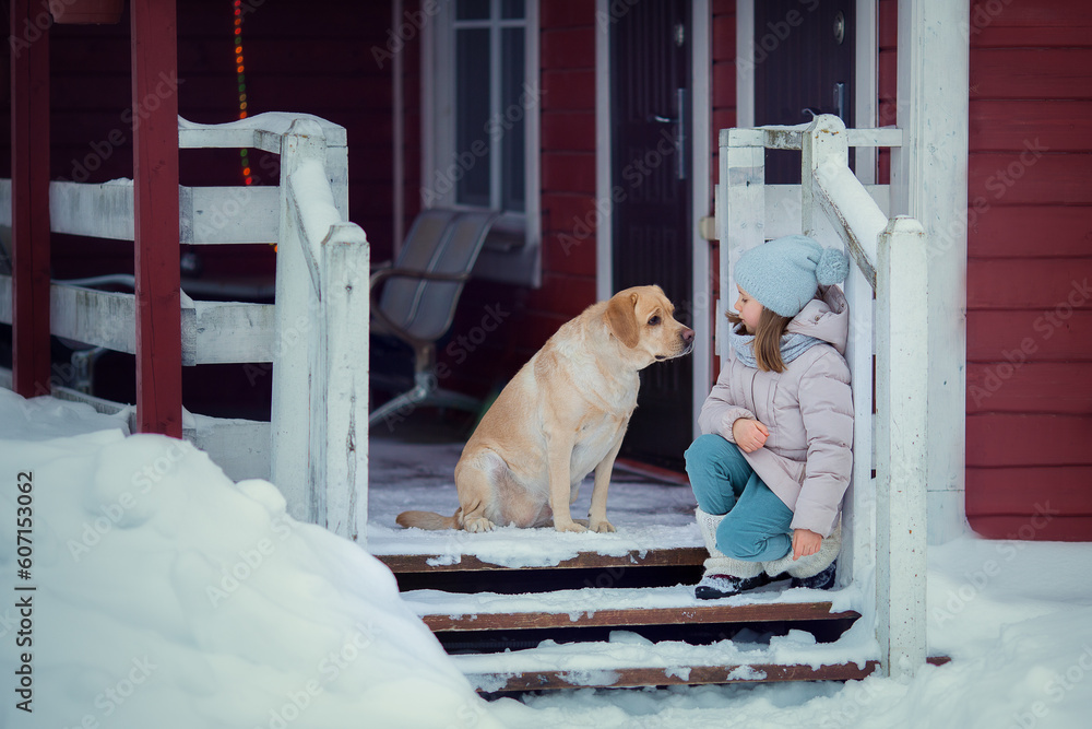 Girl with dog playing in snow