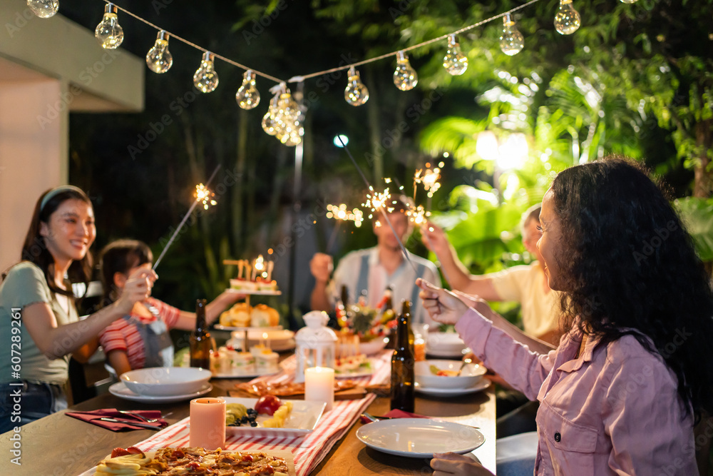 Multi-ethnic big family having fun, enjoy party outdoors in the garden. 