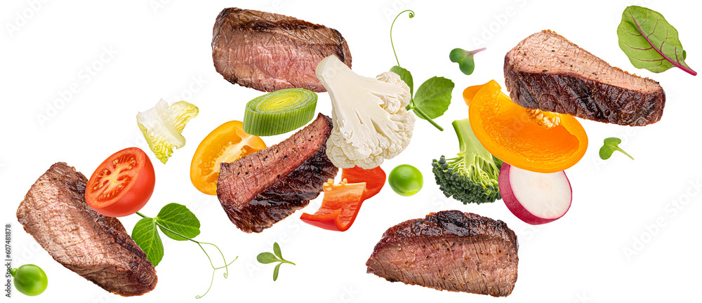 Falling steak salad ingredients isolated on white background