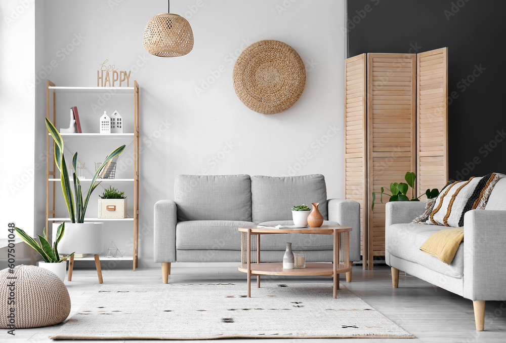 Interior of stylish living room with grey sofas and wooden coffee table