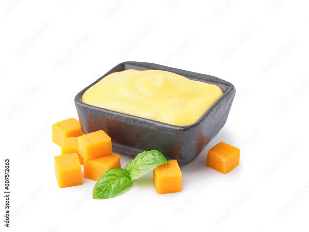 Bowl with tasty cheddar cheese sauce on white background