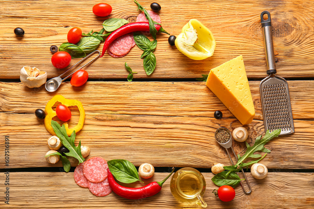 Frame made of ingredients for preparing pizza on wooden background