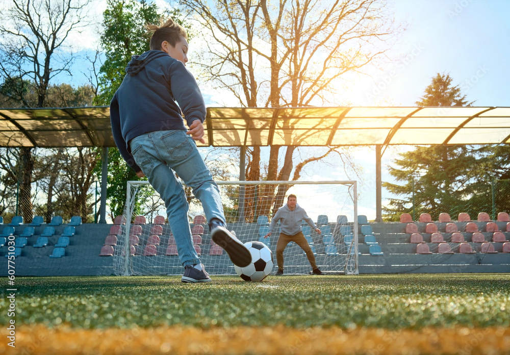 Father and Son play football on stadium outdoors, Happy family bonding, fun, players in soccer in dy