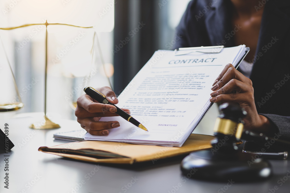 Female lawyer in a law firm holding contract documents explaining the terms of the legal agreement a