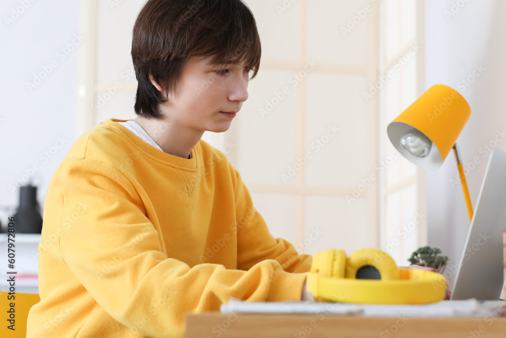 Male student studying online at home