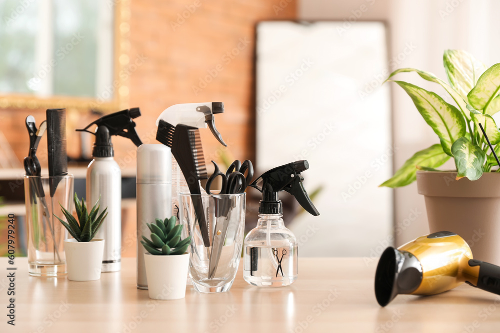 Hairdressing tools with succulents on table in beauty salon