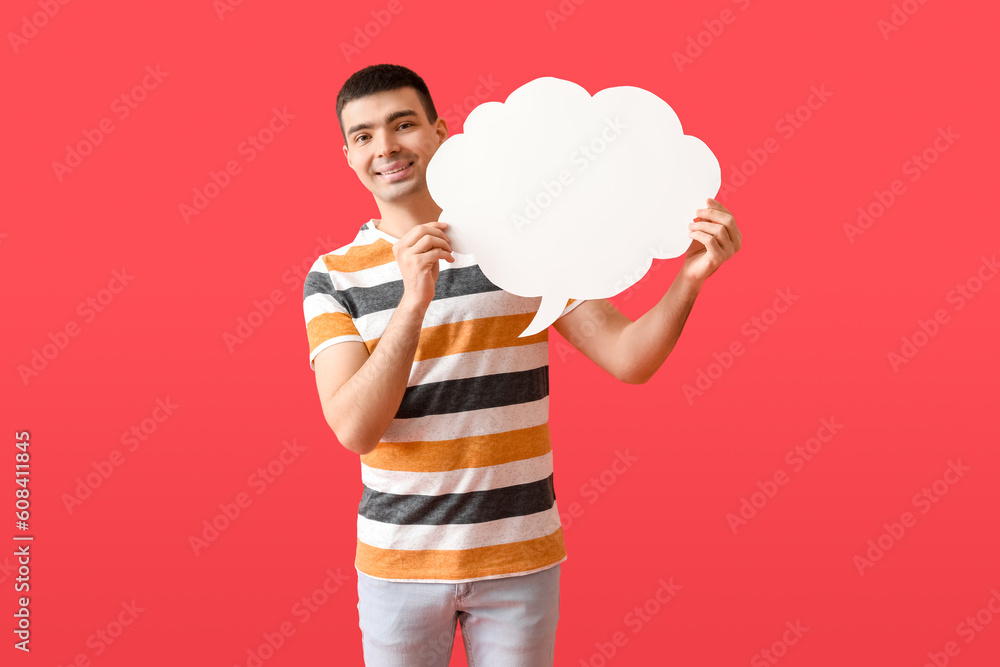 Handsome young man with blank speech bubble on red background