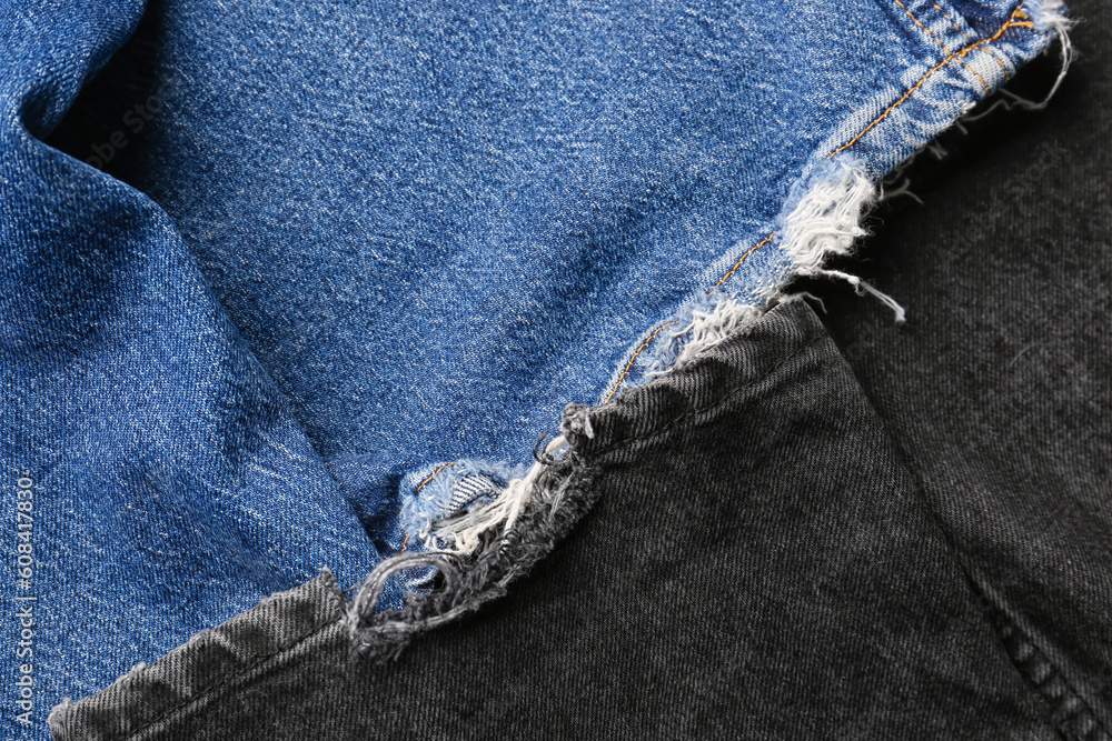 Different stylish denim jeans as background, closeup