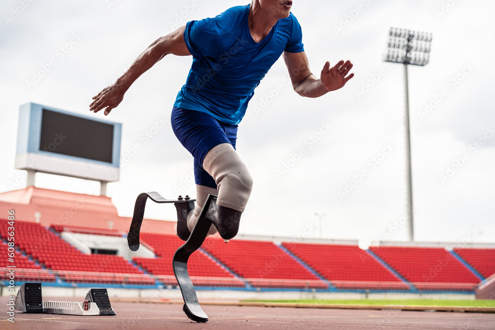 Close up of para-athletes disabled with prosthetic blades run at stadium