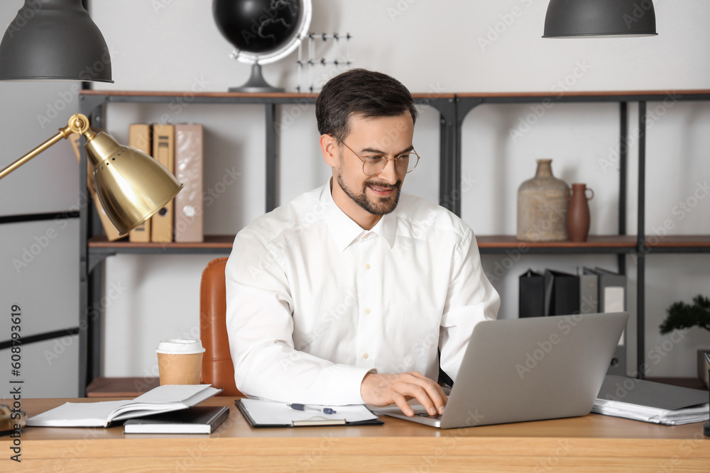 Male tutor with laptop giving online lesson at home