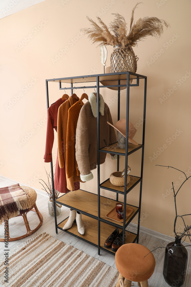 Interior of hall with shelving unit, clothes and shoes