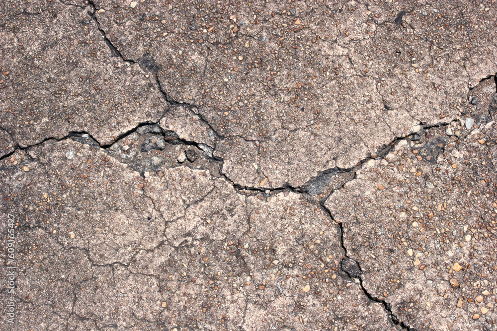 Closeup of cracked concrete surface.