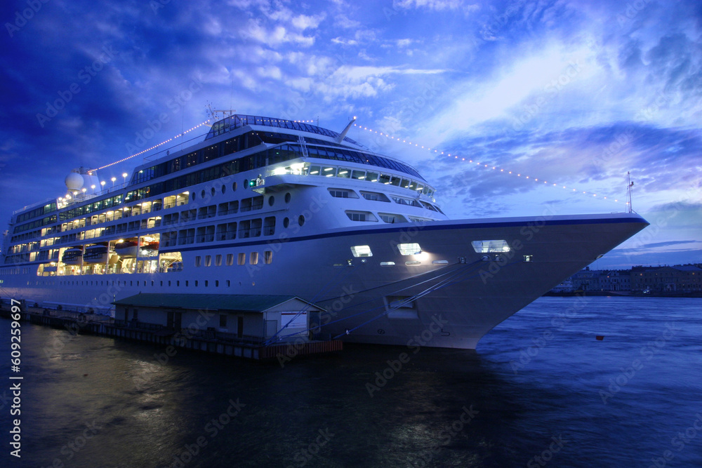 Ocean liner at St. Petersburgs port in the summer evening. Clouded skies and culm water.