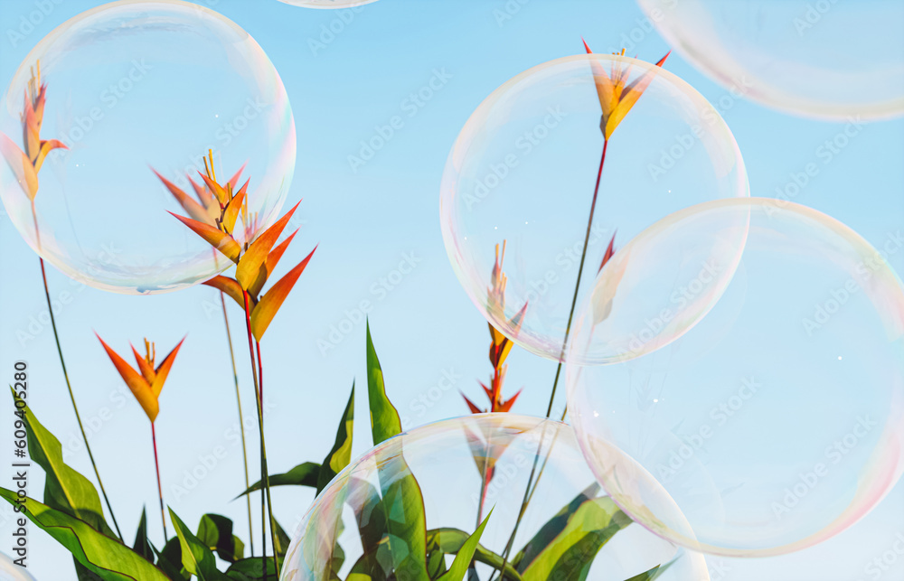 Soap bubbles with tropical plants on blue sky background. 3d rendering