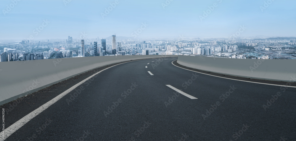 Asphalt pavement and urban building skyline