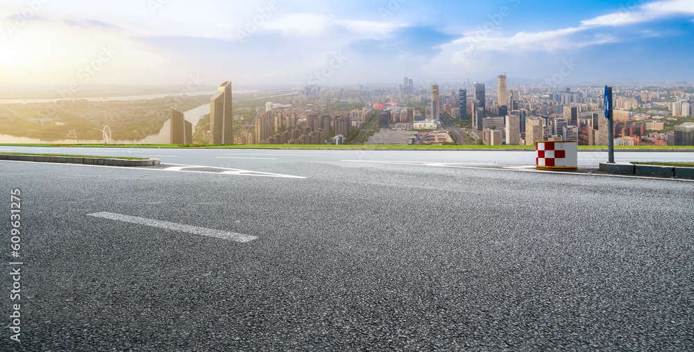 Asphalt pavement and urban building skyline