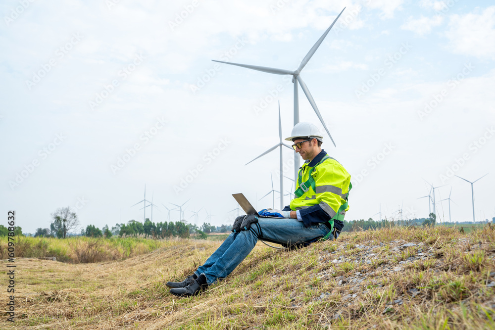 Group of engineers planning discuss project ann working in wind turbine farm,Sustainable future.