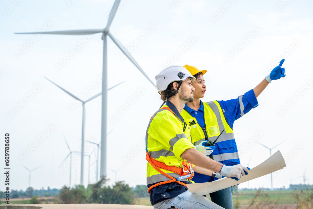 Service engineers discussing and inspection work at wind turbine farm,Renewable energy,Clean energy 