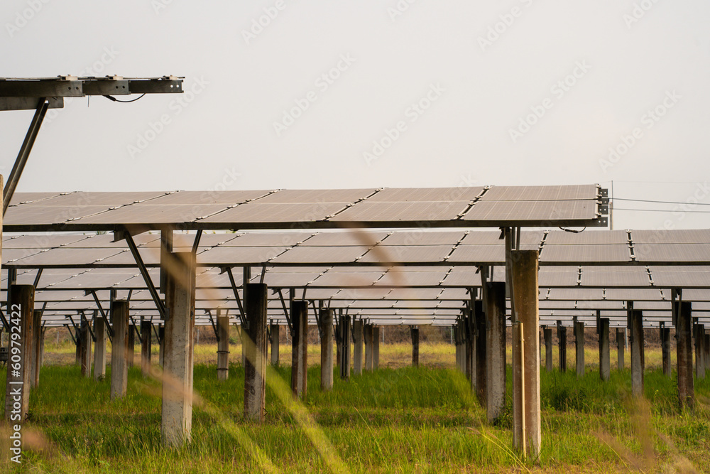 Shot of ecology solar power station panels in a field during sunset. 