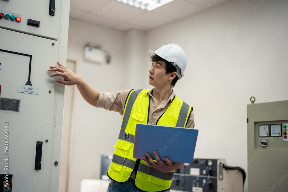 Asian attractive man industrial worker working in manufacturing plant. 